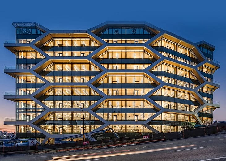A night view of the 10-story mass timber office building known as The Hive located in Vancouver, British Columbia.