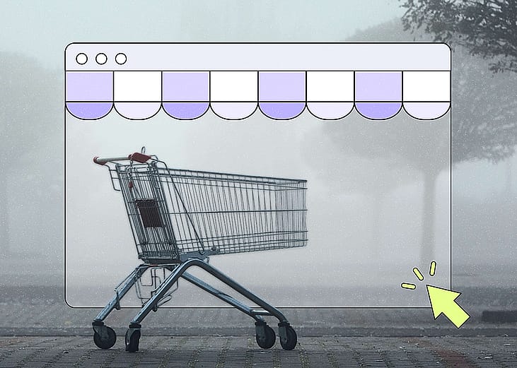 A shopping cart sits alone on a foggy, misty street, framed inside an illustrated browser window with a purple scalloped storefront awning. A yellow cursor arrow points toward the bottom right corner of the browser frame.