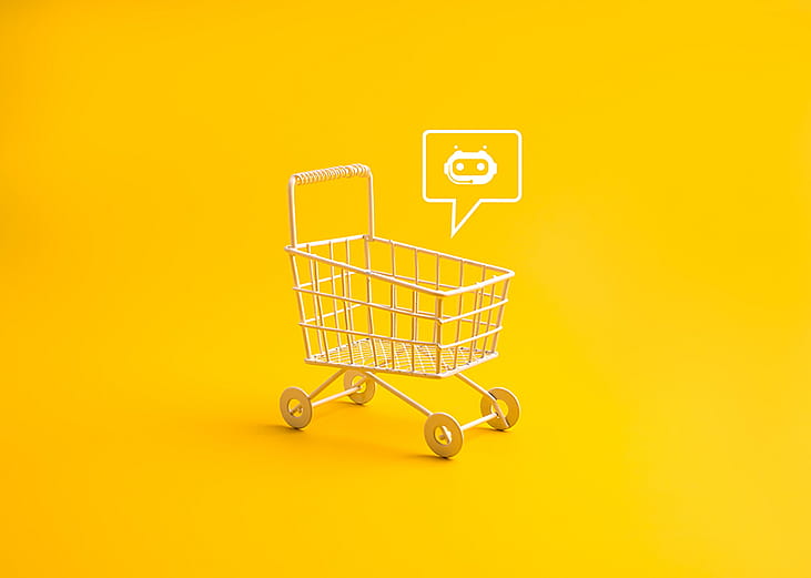 A shopping cart with a AI chatbot icon in a yellow background.