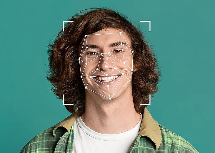 A young man illustrated with a face recognition graphic as a concept of deepfakes.