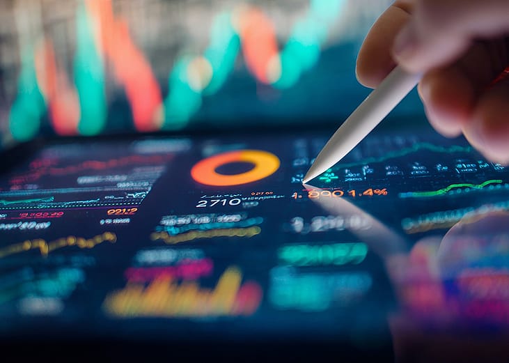 A smart pen navigating a finance dashboard displayed on a tablet.