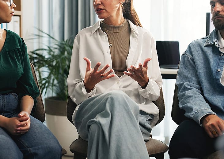 A small group of employees discussing about stress management in the workplace.