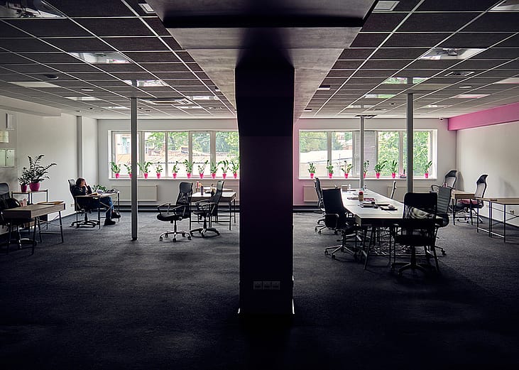 A female employee alone in a big office.