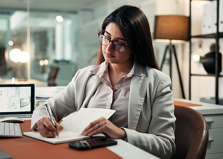 An employee planning schedules with a calendar for corporate activities at work.
