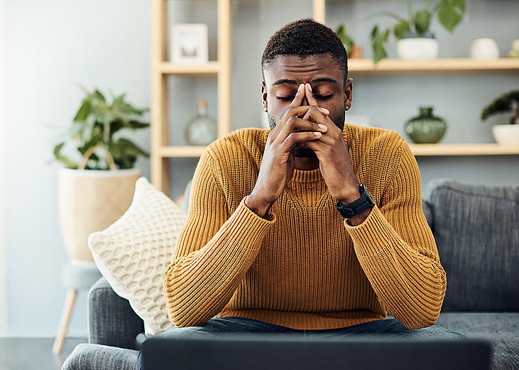 A person looking stressed out at home. 