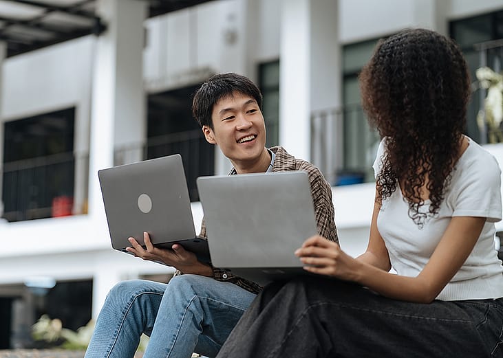 University students sharing conversations outdoors in the campus.