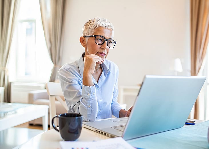 A middle-aged businesswoman working from home.