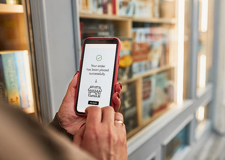 A person paying an online item through a mobile payment app in a smartphone.