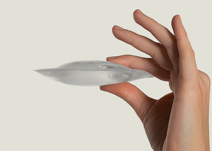 Person holding a pair of silicon gel bra inserts.