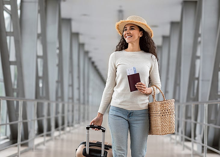 A traveller walking her way to the airport's departure gate. 