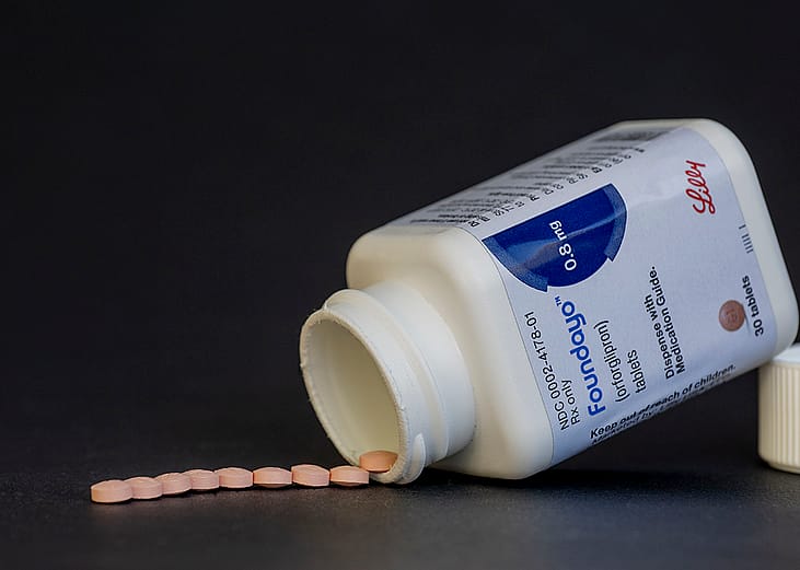 Foundayo weight loss pills neatly spilled from its bottle.