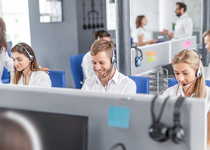 A row of call center workers at work.