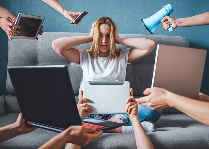 A creative image of a young woman trying to shut out digital devices as a concept of digital detox.