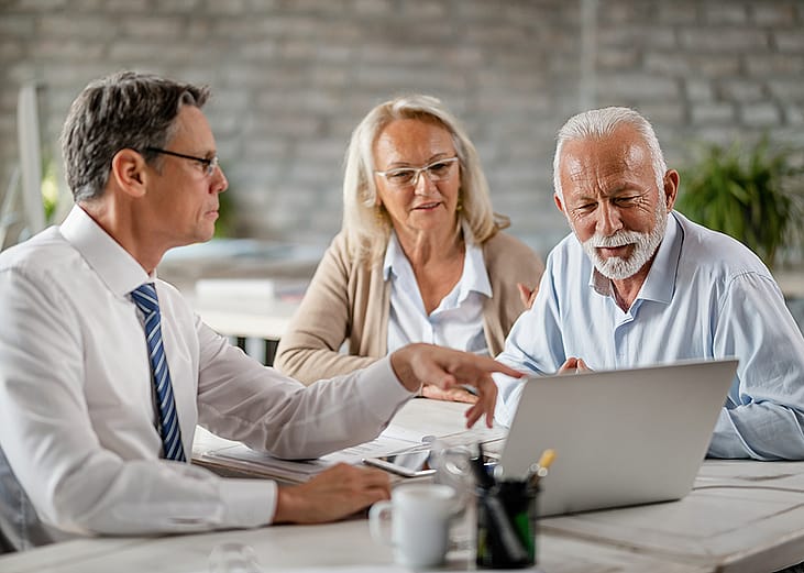 A senior couple having a meeting with a financial advisor.