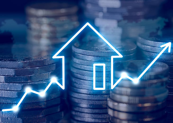 Stacks of coins with a house icon and an arrow pointing upward to the right.