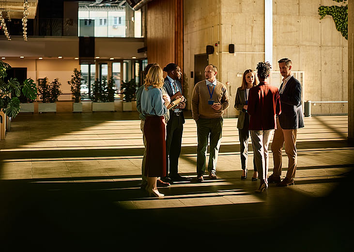 A group of entrepreneurs engaged in discussion at a conference venue.
