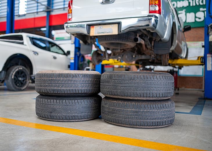 A stack of used tires in an auto repair shop.