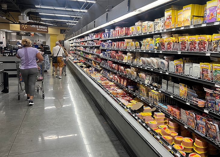 Customers shop in the deli meat aisle of a grocery store in Miami, Florida.