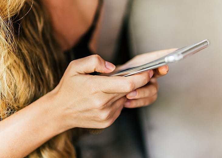 A woman texting on her phone.