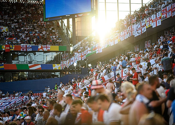 Crowds cheering during a soccer match.