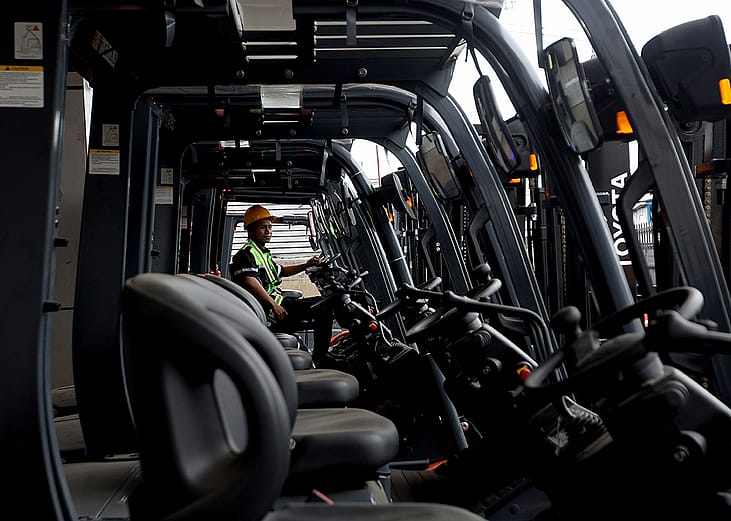 An operating trying out a new electric forklift.