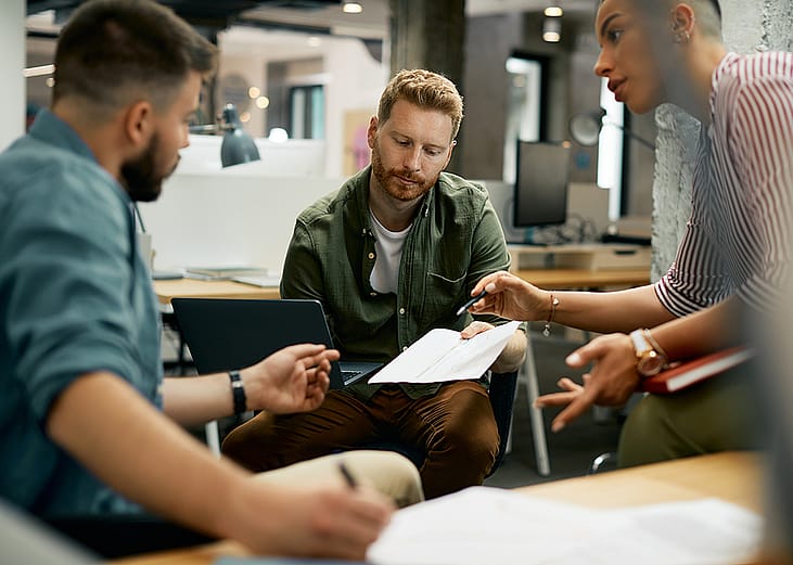 Freelance workers discussing a report.