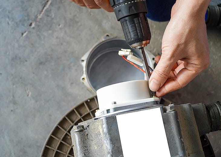 A repairman removing servo electric motor in a workshop.