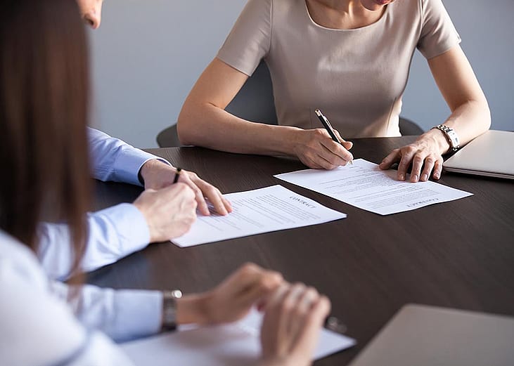 New business partners fill out a document form.