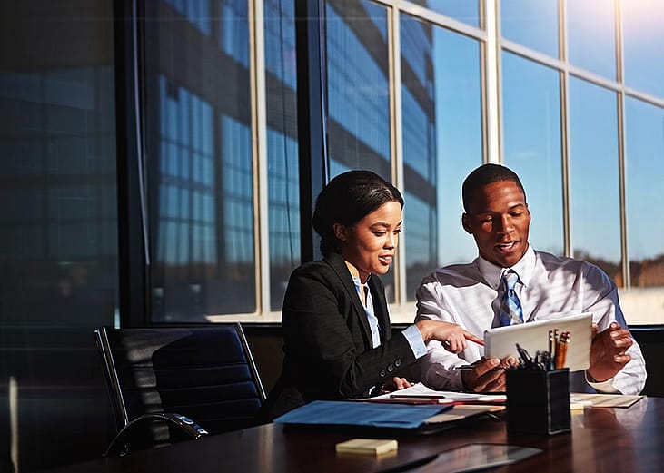 Business account managers collaborating for a revenue report and budget review in an office room.