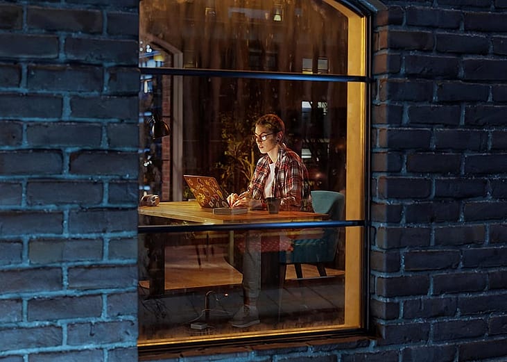 A view from the window of a female creative professional working late at night.