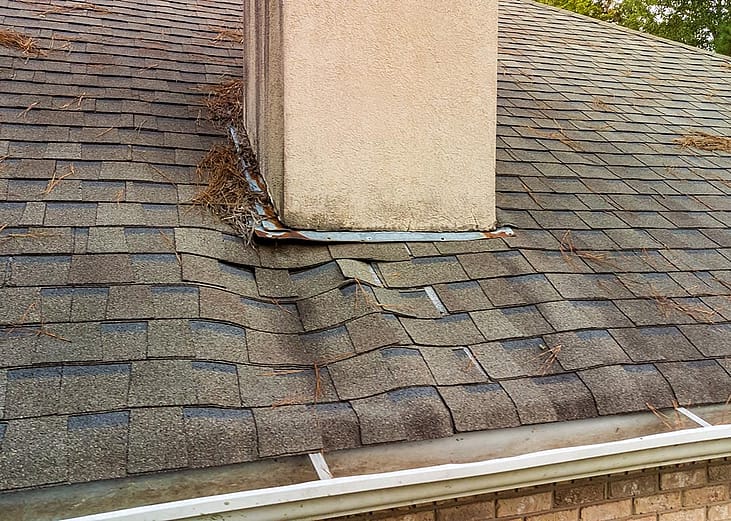 A roof's shingles damaged from a water leak.