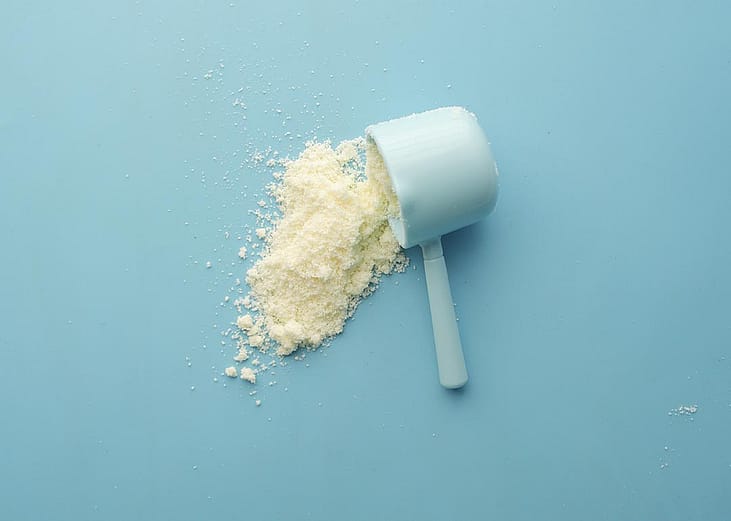 A spilled baby milk powder in a milk scooper.