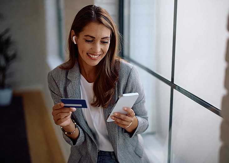 A female entrepreneur paying an online purchase with a credit card.
