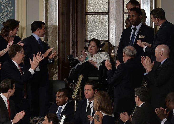 Megan Crowley (C), a Pompe Disease patient, applauded as US President Donald Trump addresses a joint session of the US Congress on February 28, 2017 at the Capitol in Washington, DC. 