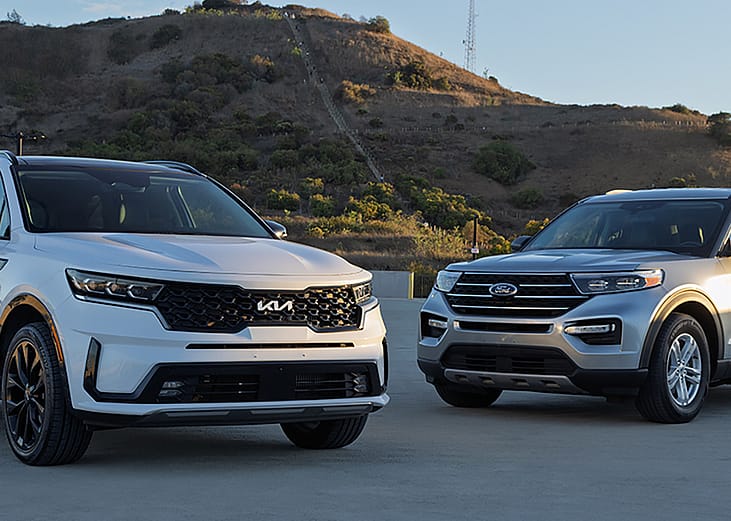 Ford Explorer and Kia Sorento cars parked outdoors.