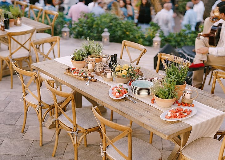 Decorated tables arranged for a rustic wedding dinner.