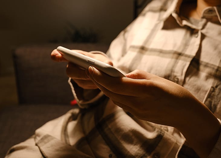 A person checking her social media accounts from her smartphone.