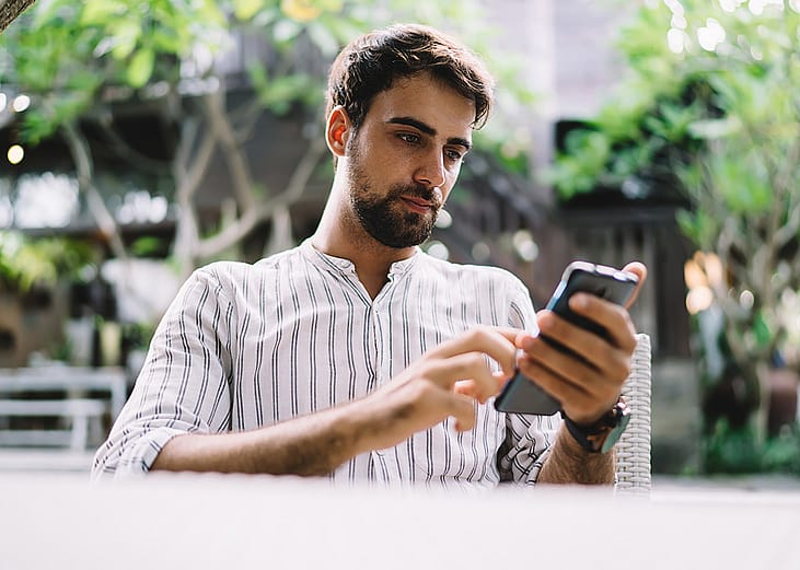 A young businessman browsing information on his phone.