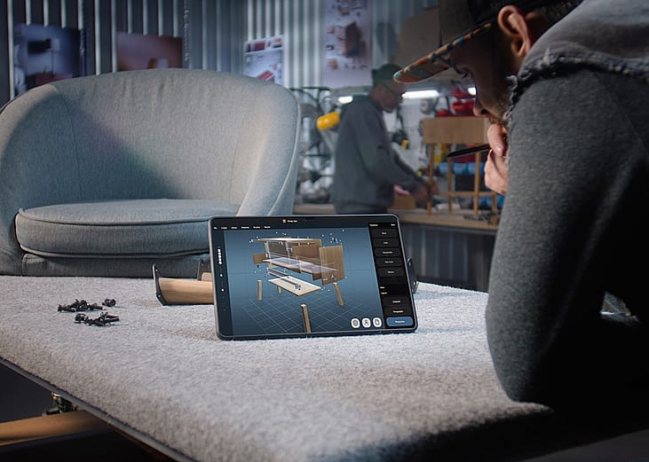 A designer creating a 3D model of a wooden bedside table through a AI software for furniture design.