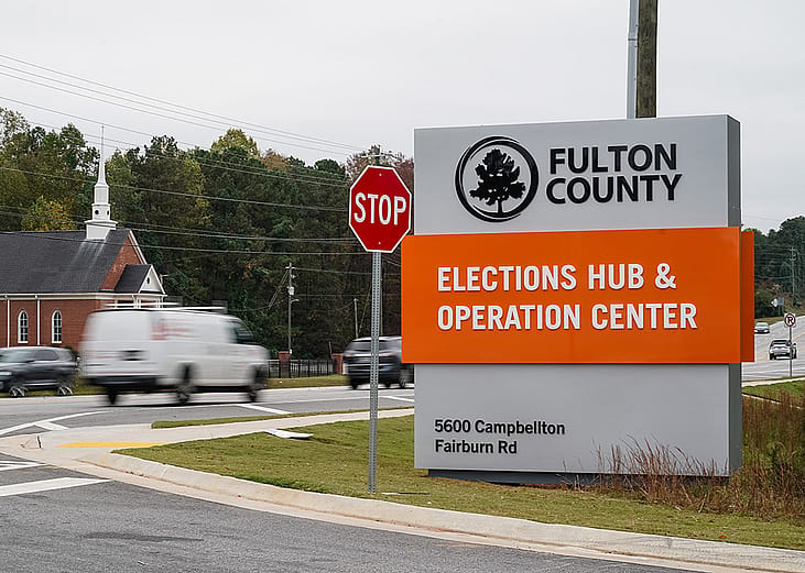 Vehicles pass by the sign for the Fulton County Elections Hub and Operations Center on November 4, 2024, in Union City, Georgia. 