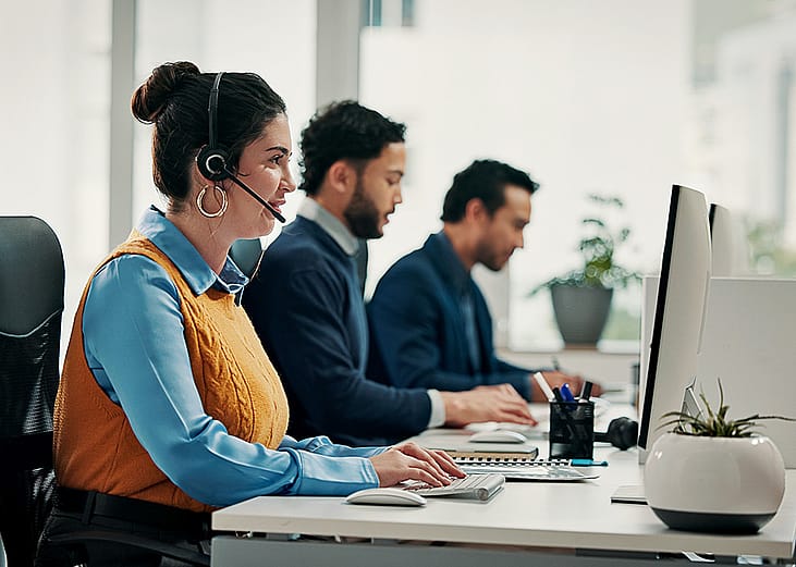 A call center employee talking with a customer over a call for solution support.