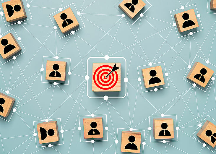 A red dartboard with human customer icons surrounding its connective map as a concept of customer target troup.