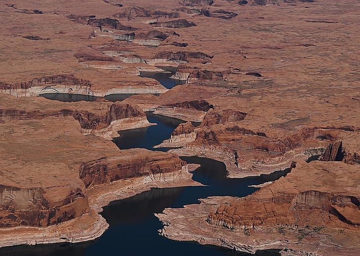 A bathtub ring marks the receded shoreline at Lake Powell, where water levels remain low in Glen Canyon National Recreation Area on April 30, 2026, near Big Water, Utah. 