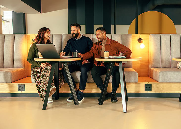 A group of young entrepreneurs working together in a lobby.