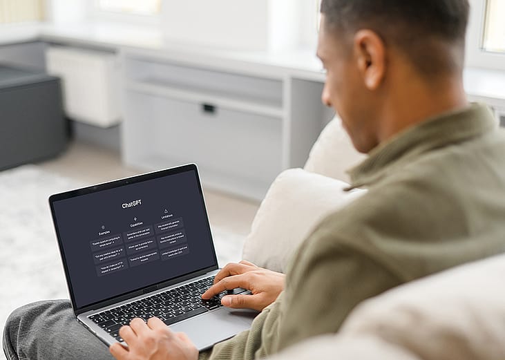 A male student using Chat GPT on a laptop.