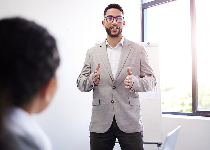 A business manager presenting a sales pitch sample during a workshop session.