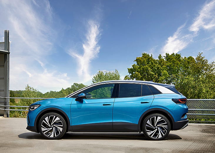 A Volkswagen ID.4, an electric crossover SUV parked in a home garage.