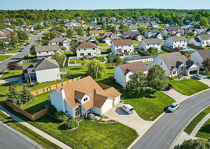 Aerial view of a residential area with two story houses.