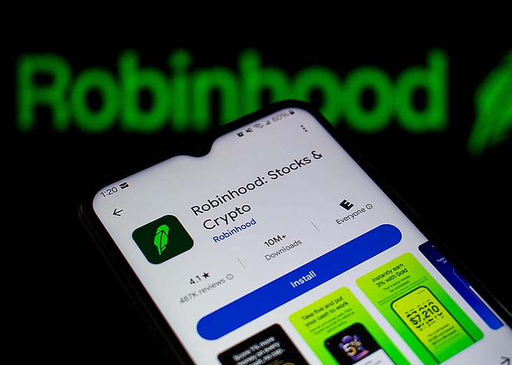 Robinhood, a financial investing app, and its logo displayed on a smartphone.