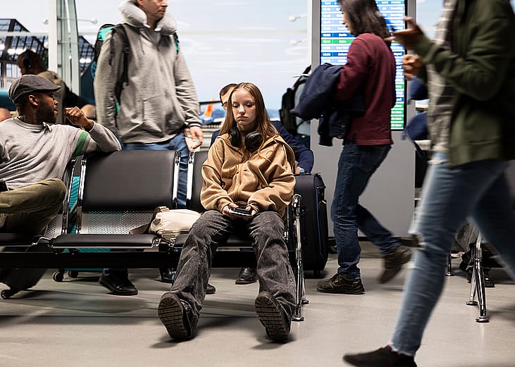 An upset young woman at the airport after a delayed flight.